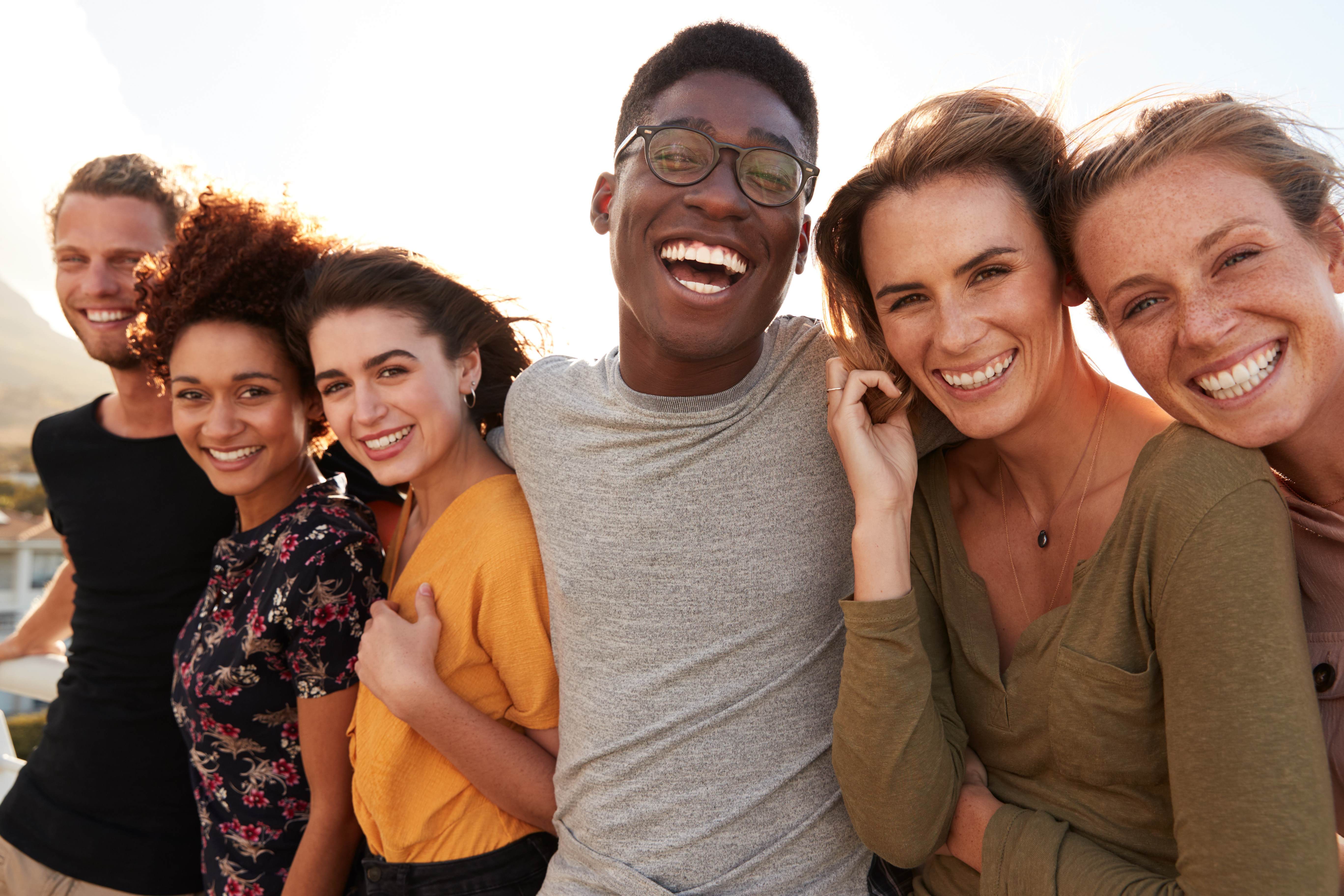 group of people smiling for people positive commitment
